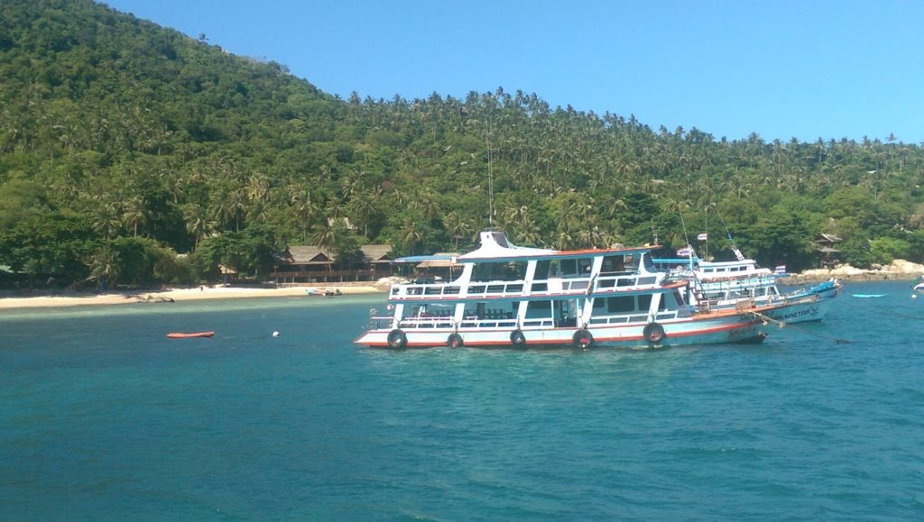 A diving boat with one of the main beachfronts in the background